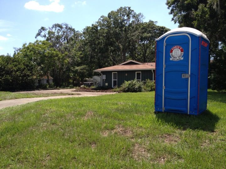 Outhouse in the yard by a home.