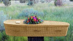 Basket style coffin with flower on top.