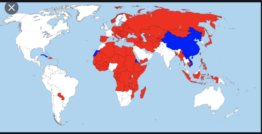 World map with some countries colored in red and others colored in blue, and some are white.